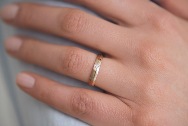 Classic gold wedding bands with diamond in her ring. - Image 2