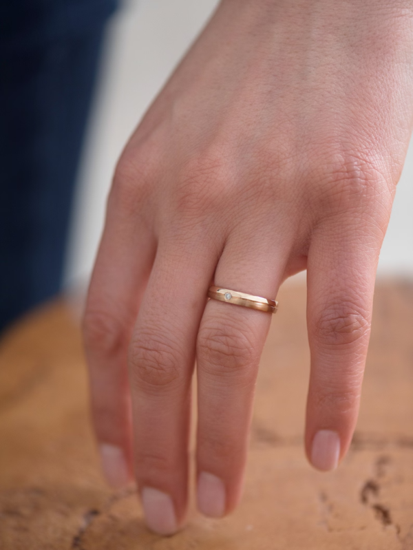 Classic gold wedding bands with diamond in her ring. - Image 3