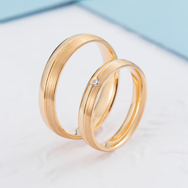 Classic gold wedding bands with diamond in her ring. - Image 5