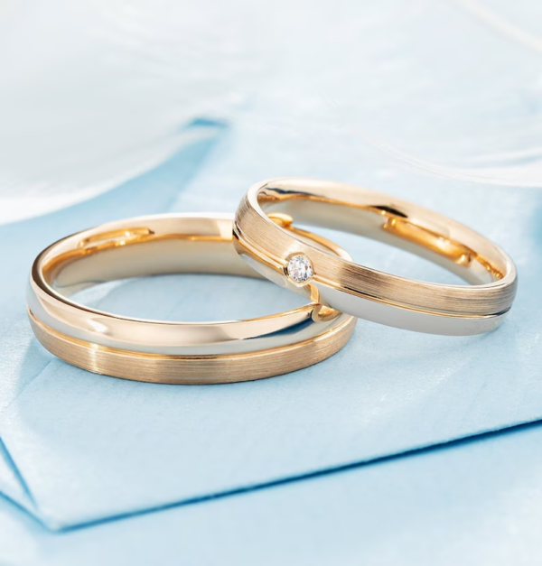 Classic gold wedding bands with diamond in her ring.